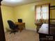 Bedroom featuring a vintage wood dresser, desk, chair, and natural light at 2730 Medlin Rd, Monroe, NC 28112