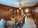 Wood paneled dining room adjacent to kitchen, featuring a china cabinet at 2730 Medlin Rd, Monroe, NC 28112