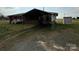 Exterior view showing a covered parking area, shed, and brick exterior of the home at 2730 Medlin Rd, Monroe, NC 28112