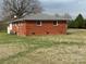 Rear exterior view of brick home, showcasing the backyard and ample outdoor space at 2730 Medlin Rd, Monroe, NC 28112