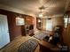The living room features wood paneling, brick wall, and patterned area rugs at 2730 Medlin Rd, Monroe, NC 28112