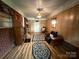 The living room features wood paneling, brick wall, and patterned area rugs at 2730 Medlin Rd, Monroe, NC 28112