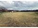 Expansive lot featuring a brick home, distant trees, and a wide open grassy area at 2730 Medlin Rd, Monroe, NC 28112