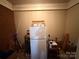 Unfinished storage area featuring a white refrigerator and miscellaneous household items at 2730 Medlin Rd, Monroe, NC 28112