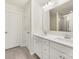 All-white bathroom with double vanity, mirror, and tile floors at 2749 Yeager Nw Dr, Concord, NC 28027