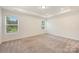 Bright bedroom with carpet floors and window views at 2749 Yeager Nw Dr, Concord, NC 28027