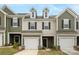 Charming townhome with attached garage, dormer windows, and modern color palette at 2749 Yeager Nw Dr, Concord, NC 28027