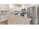Bright kitchen with stainless steel appliances, white cabinets, and granite countertops at 2749 Yeager Nw Dr, Concord, NC 28027