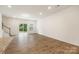 Bright living room with wood floors, patio access, and neutral wall paint at 2749 Yeager Nw Dr, Concord, NC 28027