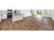 Open-concept layout with a kitchen island seamlessly connects to living area and a patio at 2749 Yeager Nw Dr, Concord, NC 28027
