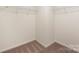 Bright walk-in closet with carpeted floor and white shelving at 2749 Yeager Nw Dr, Concord, NC 28027