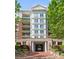 Stately building entrance framed by greenery, featuring grand columns and detailed architectural design at 300 W 5Th St # 224, Charlotte, NC 28202