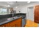 Charming kitchen showcasing wood cabinets, granite counters, and a stainless steel dishwasher at 300 W 5Th St # 224, Charlotte, NC 28202
