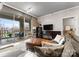 Cozy living room boasting large windows, balcony access, and stylish modern furnishings at 300 W 5Th St # 224, Charlotte, NC 28202