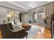 Comfortable living room with a large window that opens to a private balcony at 300 W 5Th St # 224, Charlotte, NC 28202