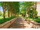 Tree-lined brick walkway surrounded by lush landscaping, providing a serene pathway through the community at 300 W 5Th St # 224, Charlotte, NC 28202