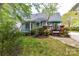 Inviting backyard featuring a wooden deck with outdoor seating and lush landscaping at 306 Ashby Dr, Davidson, NC 28036