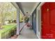 Charming covered front porch with rocking chairs, perfect for relaxing and enjoying the outdoors at 306 Ashby Dr, Davidson, NC 28036