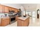 Traditional kitchen with wood cabinets, stainless steel appliances, and a center island featuring tile countertops at 306 Ashby Dr, Davidson, NC 28036
