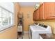 Bright laundry room with a window, storage shelves, and a modern washer and dryer set at 306 Ashby Dr, Davidson, NC 28036