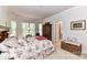 Airy main bedroom featuring a large bed, bay windows, and a walk-in closet at 306 Ashby Dr, Davidson, NC 28036