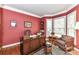 Cozy office with hardwood floors, a large wooden desk, and natural light from the windows at 306 Ashby Dr, Davidson, NC 28036