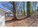 Exterior backyard view with trees and foliage in a partially wooded lot at 310 Pineview St, Kannapolis, NC 28083