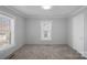 Empty bedroom with light gray walls, carpet, and a bright window view at 310 Pineview St, Kannapolis, NC 28083