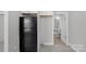 Kitchen area with black refrigerator and view into the updated bathroom at 310 Pineview St, Kannapolis, NC 28083