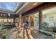 Entertain on the back porch featuring various seating arrangements, screened windows, and wooded views of the property at 32 Fairway Rdg, Lake Wylie, SC 29710