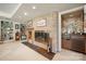 Finished basement featuring a brick fireplace, built-in bookshelves, and mirrored bar area at 32 Fairway Rdg, Lake Wylie, SC 29710
