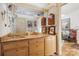 Bathroom featuring a large mirror, drawers, and a sink with decorative artwork and lighting at 32 Fairway Rdg, Lake Wylie, SC 29710