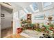 Bright bathroom with skylights, showcasing a bathtub surrounded by lush plants and decor at 32 Fairway Rdg, Lake Wylie, SC 29710