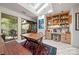 Sunlit dining area with a skylight, wooden table, built-in shelving, and easy access to the outdoor deck at 32 Fairway Rdg, Lake Wylie, SC 29710