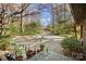 Long driveway leading to the house; several potted plants sitting on the front stoop at 32 Fairway Rdg, Lake Wylie, SC 29710