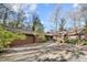 Exterior shot of a contemporary home showcasing its well-maintained driveway and landscaping at 32 Fairway Rdg, Lake Wylie, SC 29710