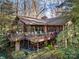 Two-story home with a large deck overlooking a lush, wooded yard, perfect for outdoor entertaining at 32 Fairway Rdg, Lake Wylie, SC 29710