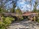 Charming single-story home with an attached garage, mature trees, and a spacious driveway at 32 Fairway Rdg, Lake Wylie, SC 29710