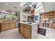Bright kitchen featuring a skylight, island with a sink, white tile flooring, and white cabinets, perfect for culinary enthusiasts at 32 Fairway Rdg, Lake Wylie, SC 29710