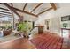 Open-concept living space with exposed beams and abundant natural light, showcasing a modern design at 32 Fairway Rdg, Lake Wylie, SC 29710