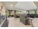 Spacious living room with a brick fireplace, multiple seating areas, and a view of the outdoors at 32 Fairway Rdg, Lake Wylie, SC 29710