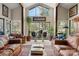 Bright living room with large windows, vaulted ceilings, and comfortable seating, ideal for relaxation at 32 Fairway Rdg, Lake Wylie, SC 29710