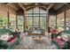 Relaxing screened-in porch with comfortable wicker furniture, perfect for enjoying the outdoors at 32 Fairway Rdg, Lake Wylie, SC 29710