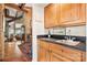 Enjoy a wet bar featuring wood cabinets and a sink for easy entertaining in this home with an open floor plan at 32 Fairway Rdg, Lake Wylie, SC 29710