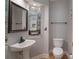 Stylish powder room with pedestal sink, decorative mirror, and updated fixtures at 3304 Taviston Dr, Waxhaw, NC 28173