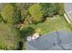 Aerial view of landscaped backyard with deck, patio furniture, and mature trees at 3304 Taviston Dr, Waxhaw, NC 28173
