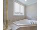 Relaxing soaking tub with tiled surround, perfect for unwinding after a long day at 3304 Taviston Dr, Waxhaw, NC 28173