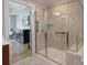 Bathroom featuring a tiled glass shower and access to the main bedroom at 3304 Taviston Dr, Waxhaw, NC 28173