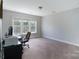 Bedroom with carpet, a large window, desk, and an office chair at 3304 Taviston Dr, Waxhaw, NC 28173
