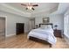 Spacious bedroom featuring a tray ceiling, hardwood floors, and matching dark wood furniture at 3304 Taviston Dr, Waxhaw, NC 28173